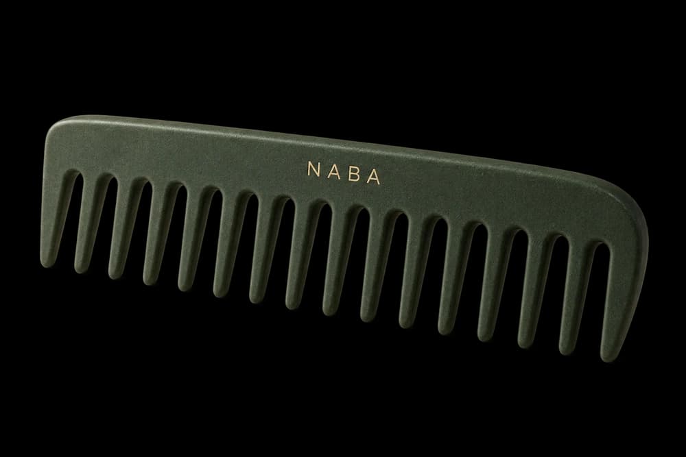 Provisional graphite-green Naba comb with long teeth and a rounded side